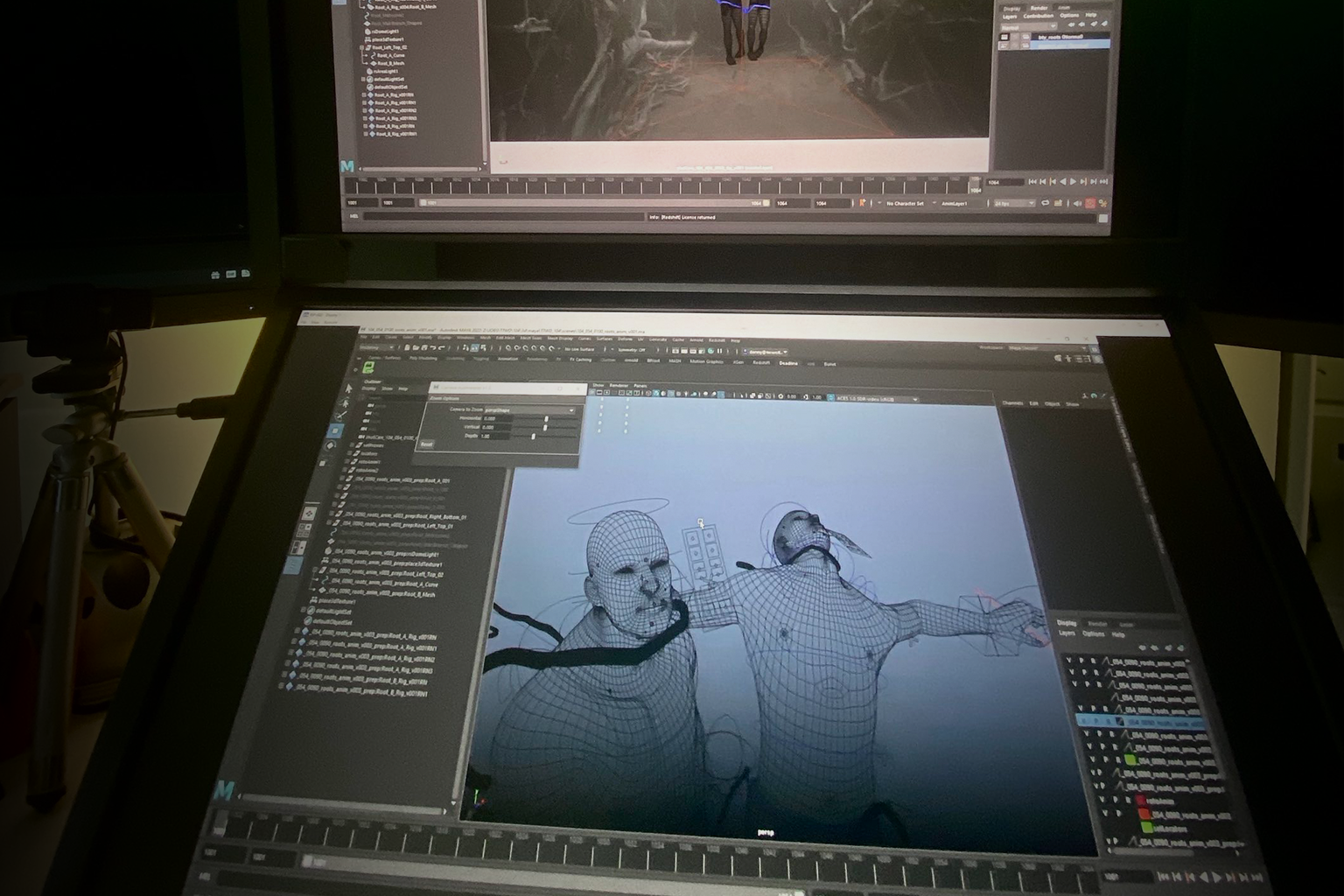 Studio workstation displaying 3D character wireframes and animation in progress